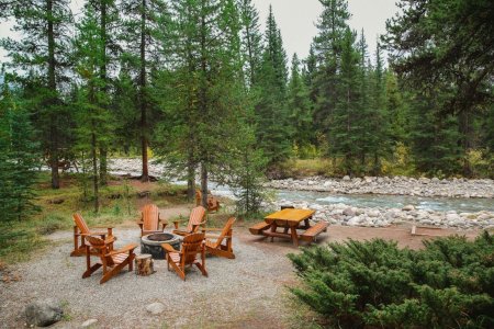 Bonfire near river at Baker Creek Chalets in Lake Louise
