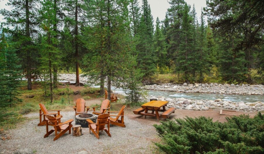Bonfire near river at Baker Creek Chalets in Lake Louise