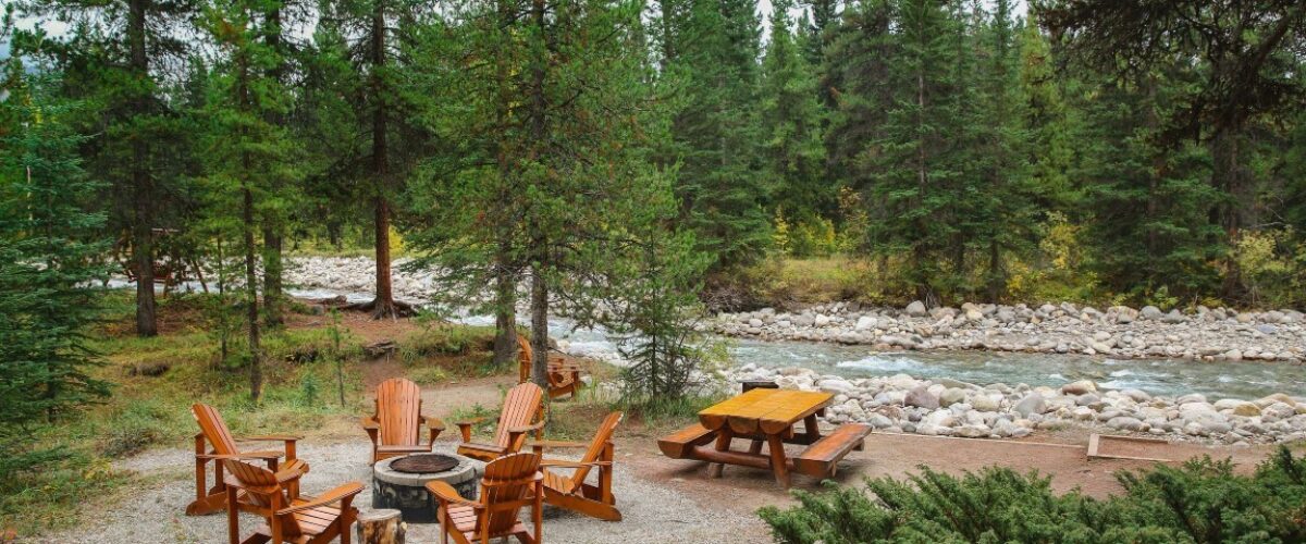 Bonfire near river at Baker Creek Chalets in Lake Louise